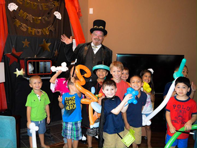 Photo of magician standing with children
